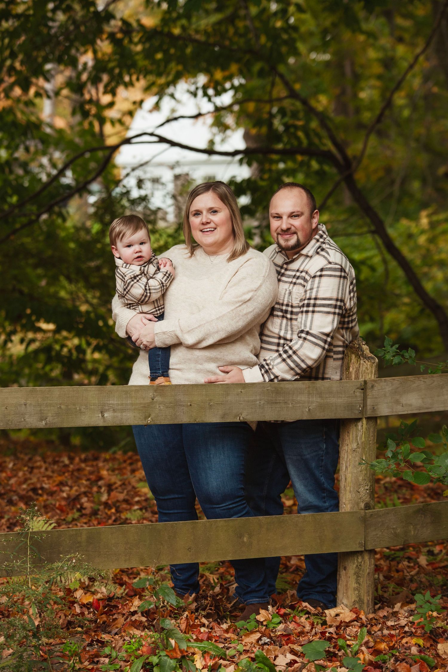 Family photo sequence on wooden fence surrounded by fall foliage.