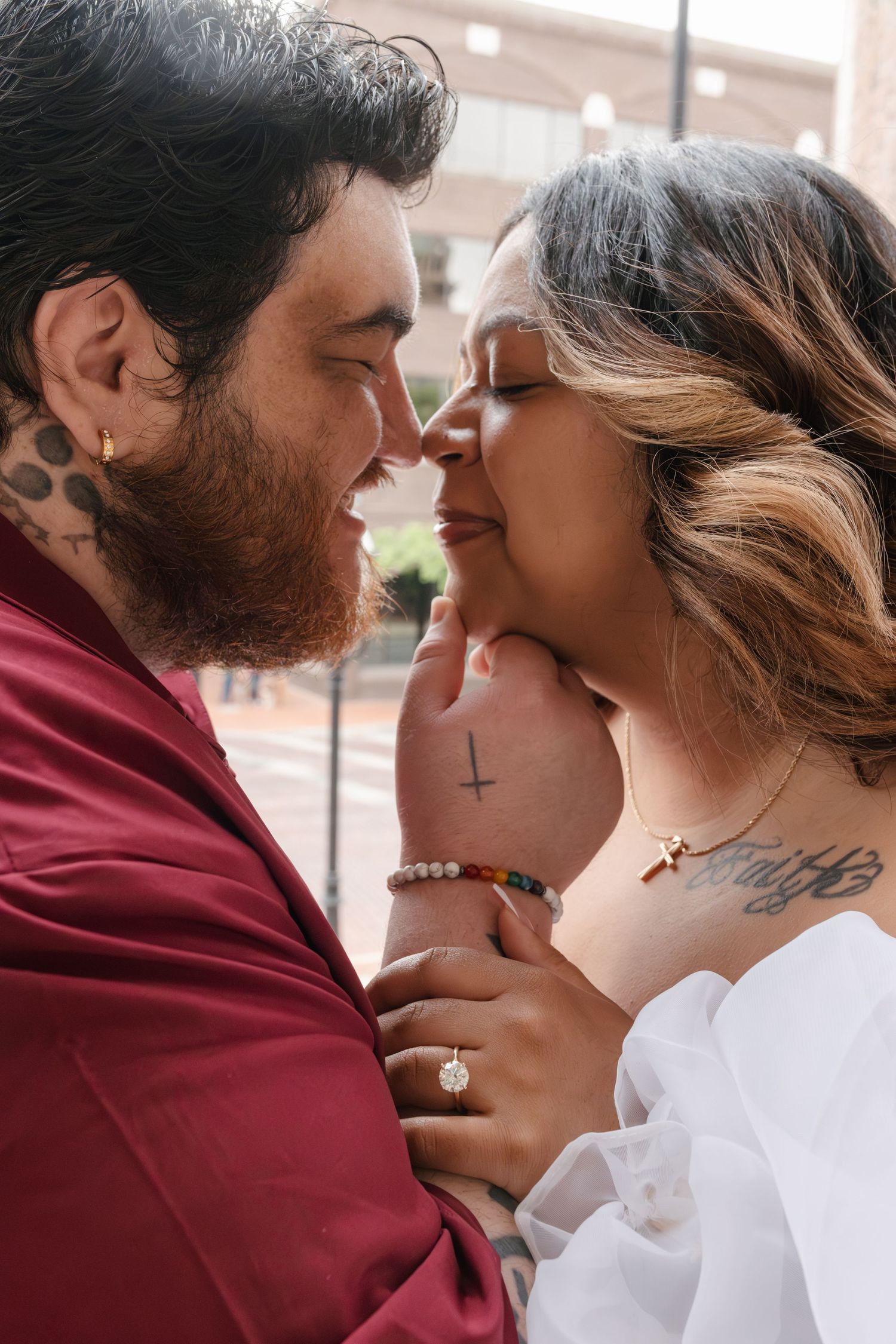 A romantic series of close-up shots showing a couple in intimate poses against a brick wall background.