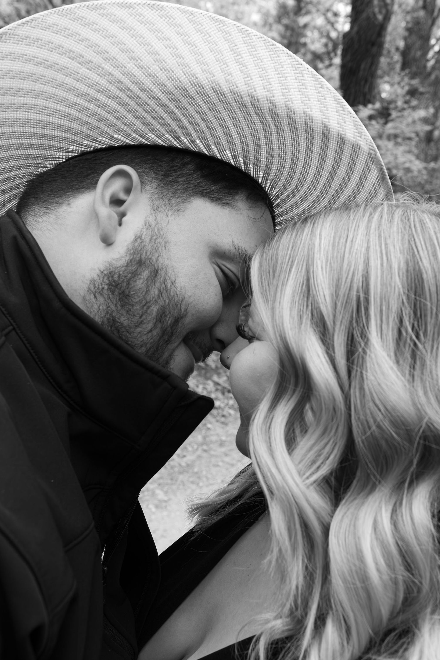 A romantic sequence of black and white photos showing an intimate moment between a couple in nature.