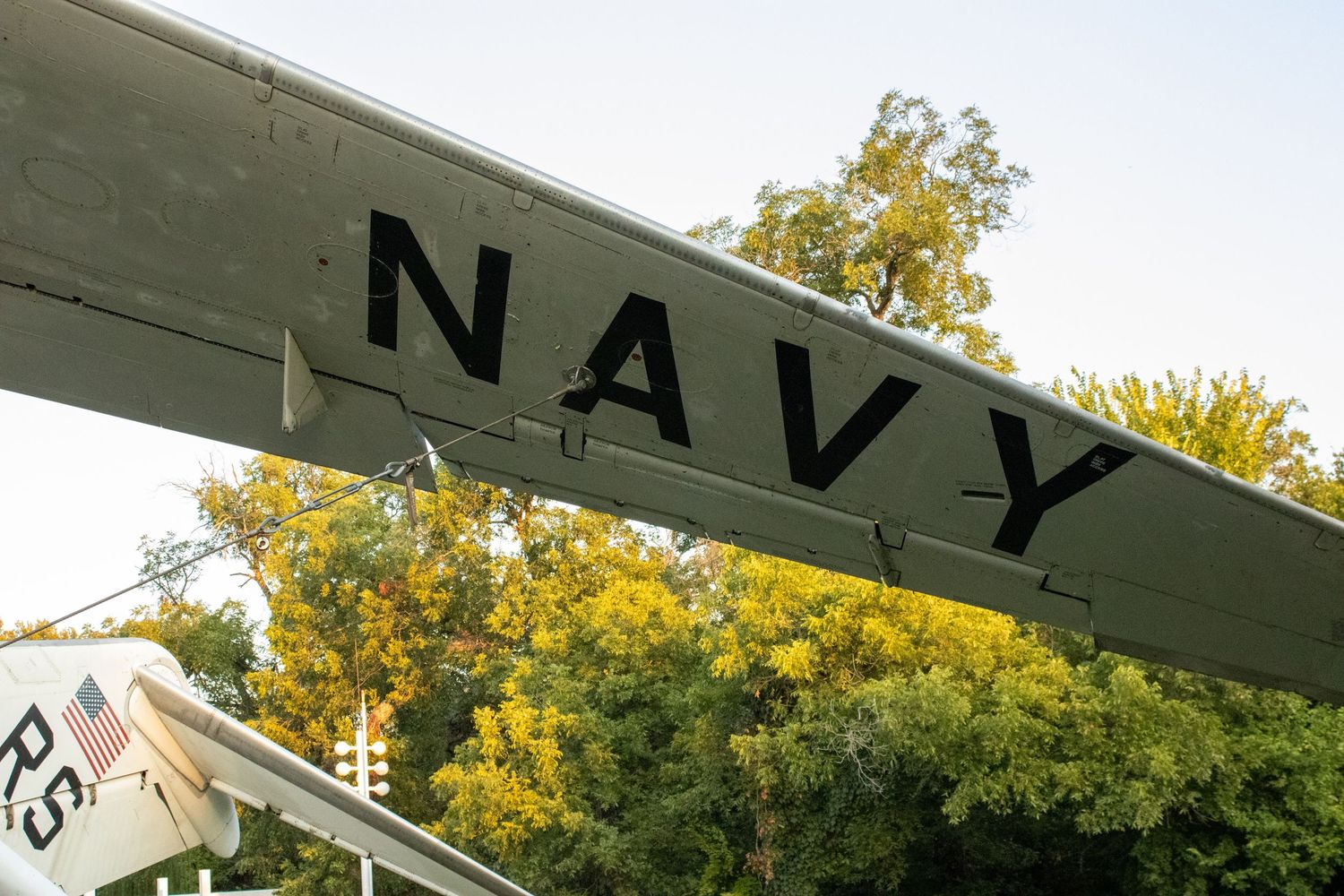 Navy text painted on a green military aircraft display.