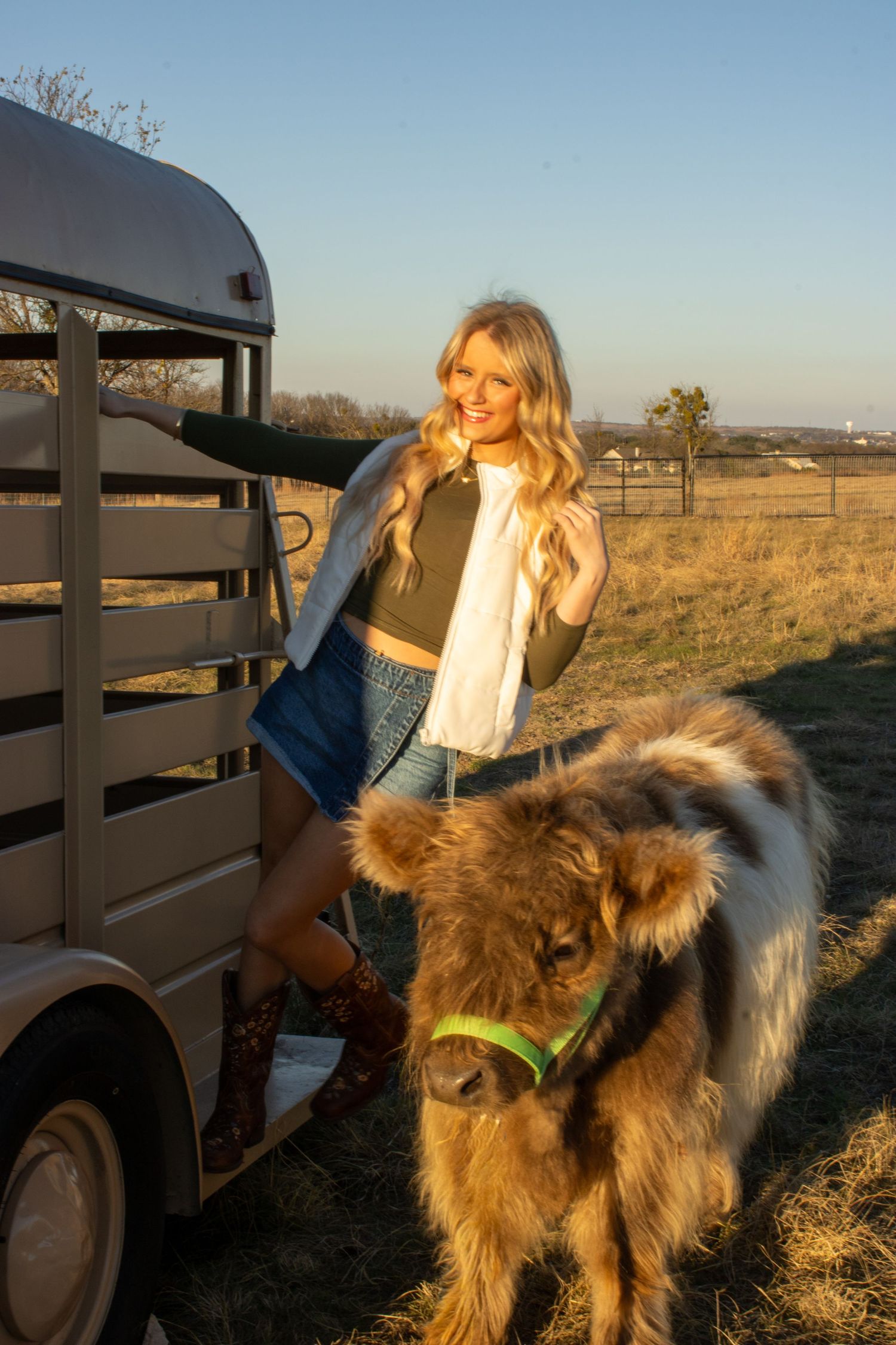 A series of photos showing someone in casual attire sitting on a fence with a fluffy brown dog in a rural setting at sunset.