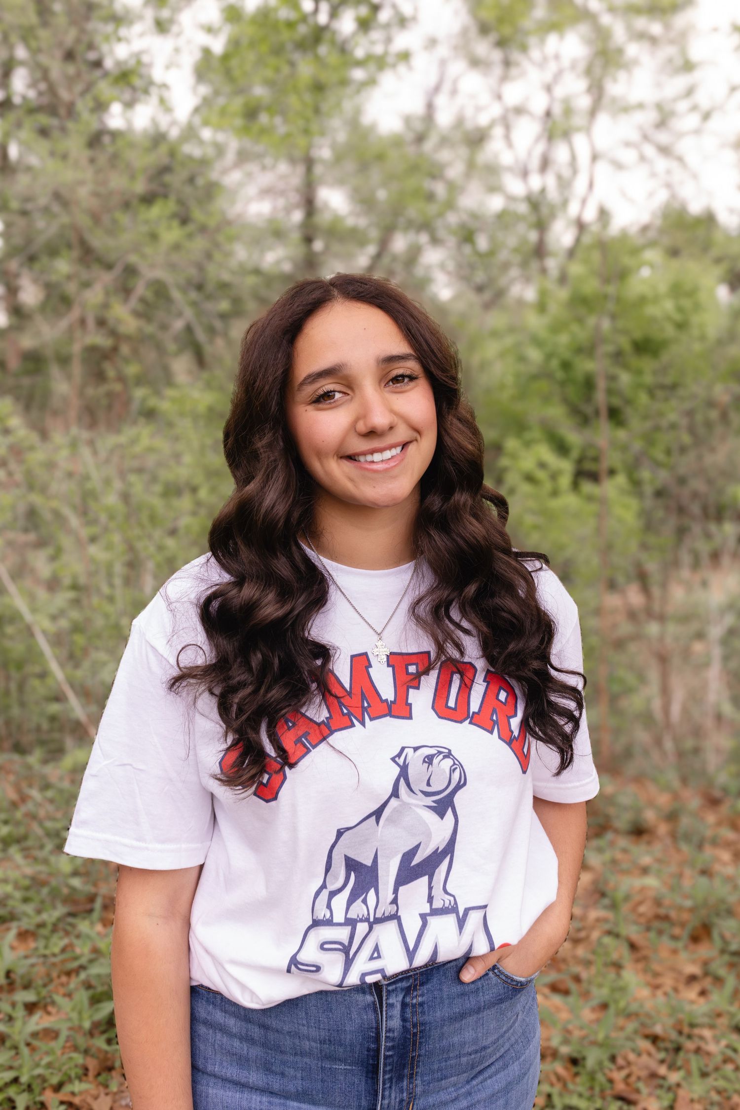A series of outdoor portrait photos showing someone in a white graphic t-shirt with blue jeans against a natural background.