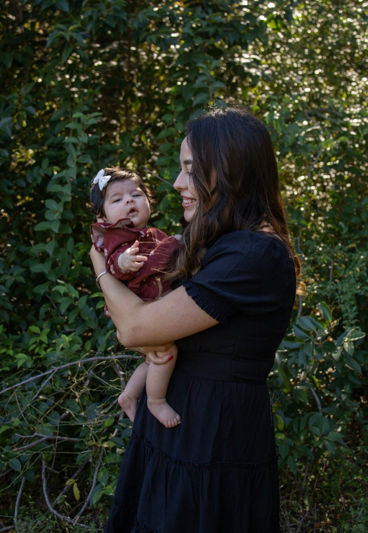 A touching outdoor moment captured in a sequence of photos showing an embrace against a natural green backdrop.