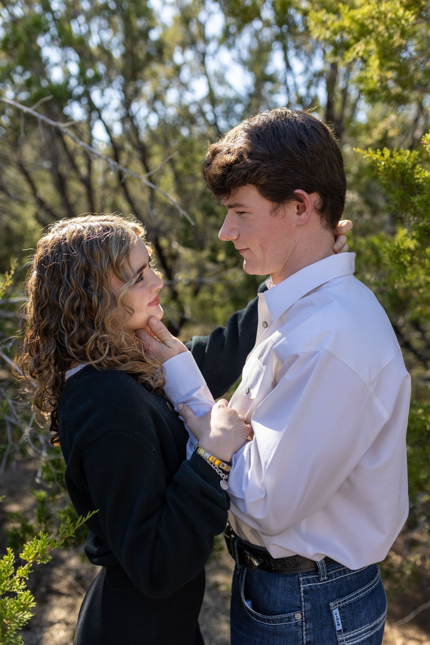 A couple in casual attire shares an intimate moment outdoors in a series of candid photographs.