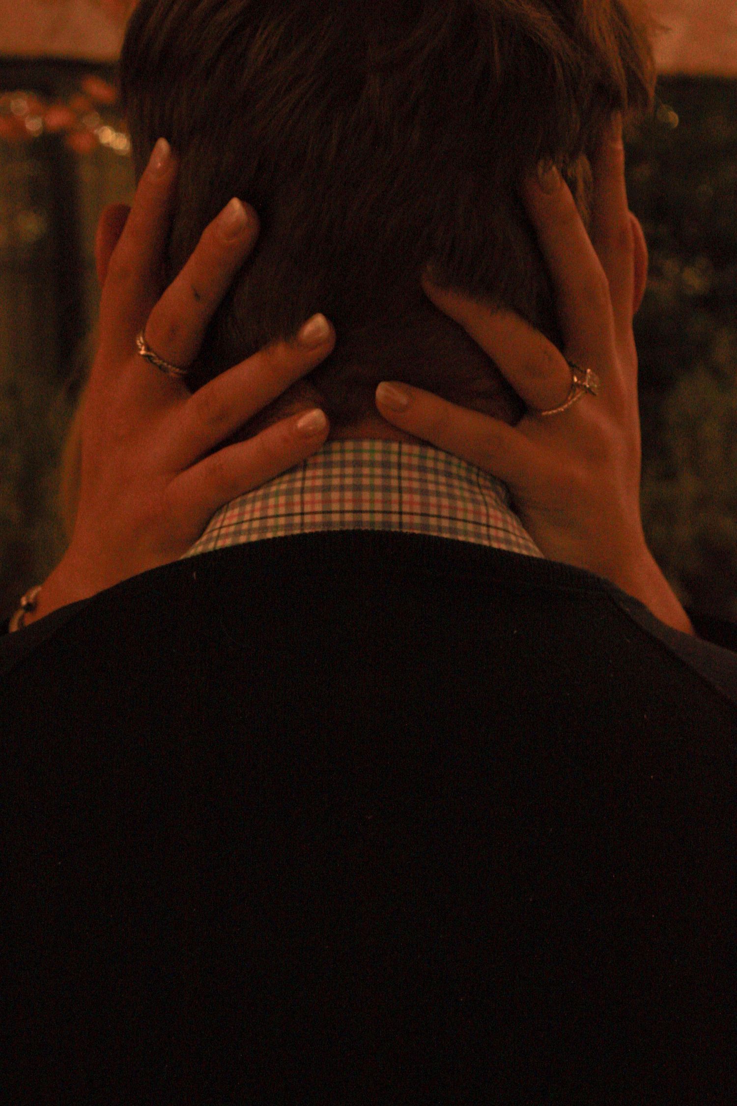A sequence of photos showing hands covering the back of a head wearing a plaid shirt against a dark background.