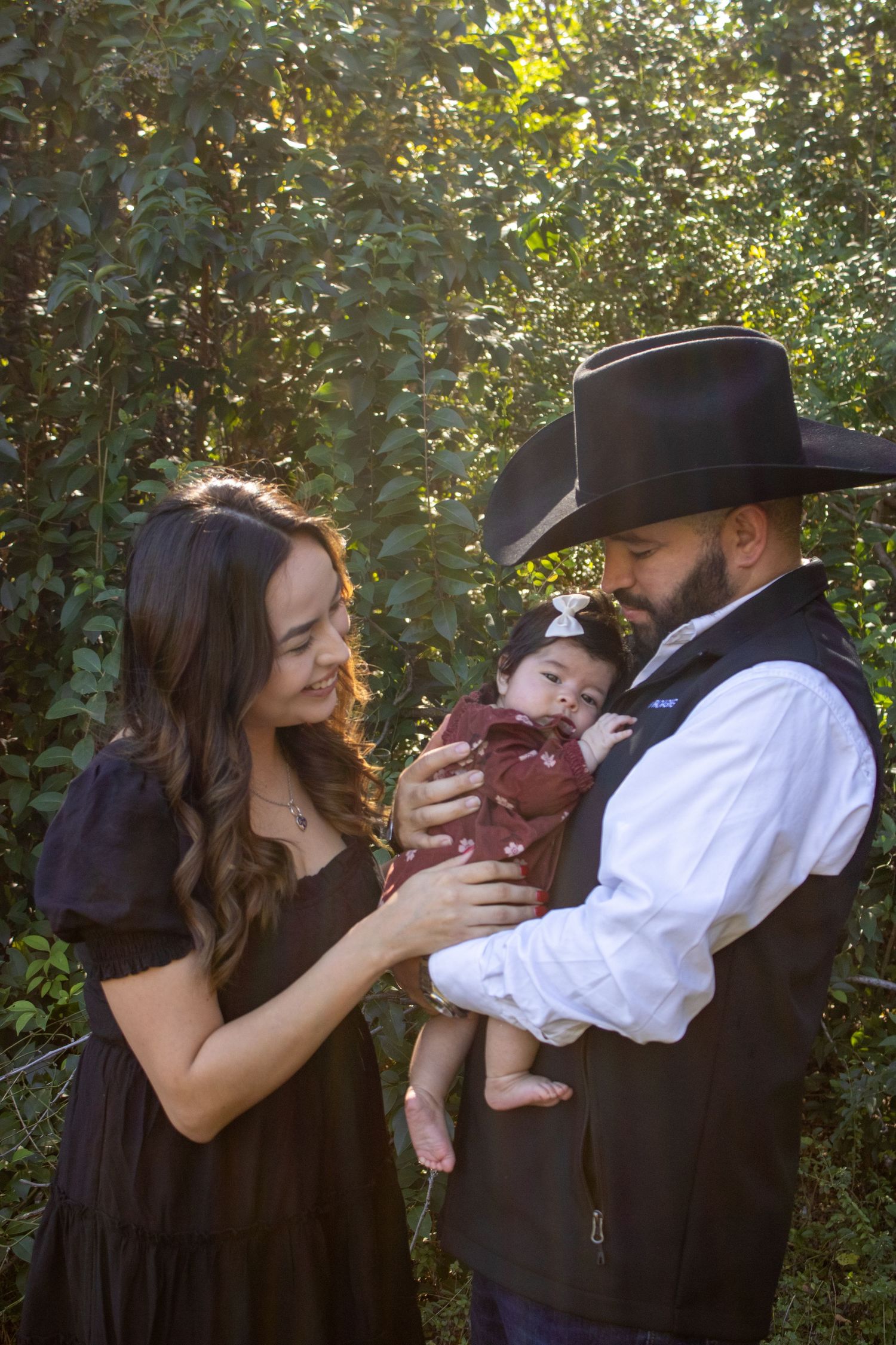 A couple in vintage attire share tender moments with a baby outdoors in a progressive photo sequence.