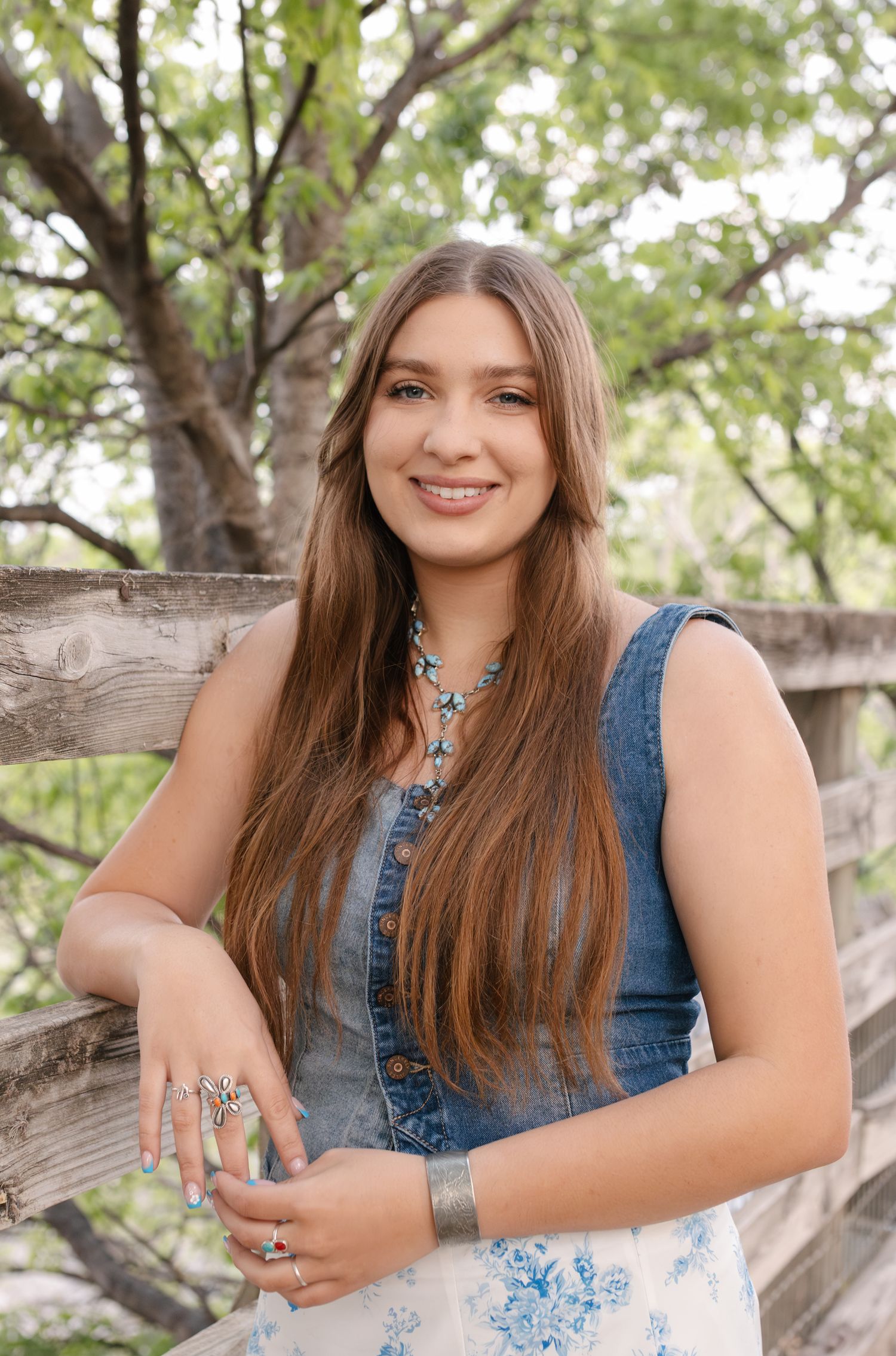 A series of outdoor portrait photographs featuring someone in a denim top against a rustic wooden fence and natural background.