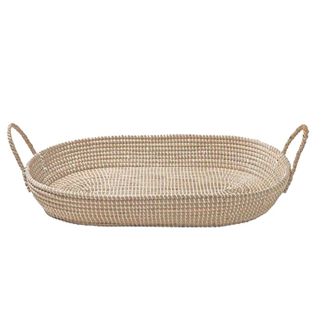 Large oval handwoven seagrass changing basket tray with side handles in natural beige tone.