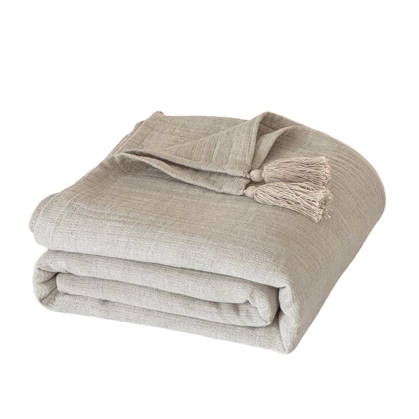 A neatly folded beige linen throw blanket with decorative fringe tassels on a white background.
