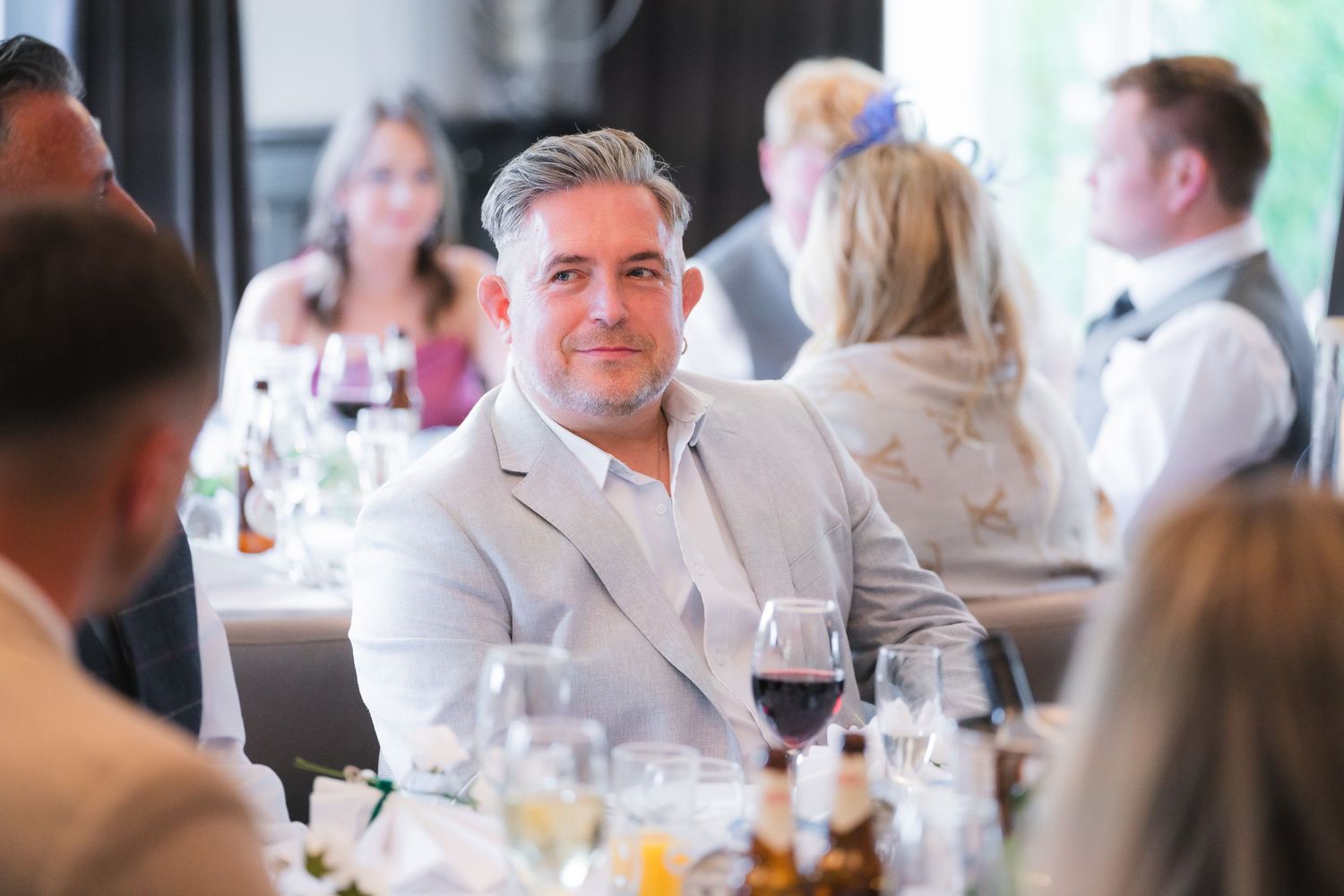 Candid shots of guests enjoying the wedding reception with laughter, toasts, and genuine moments.
