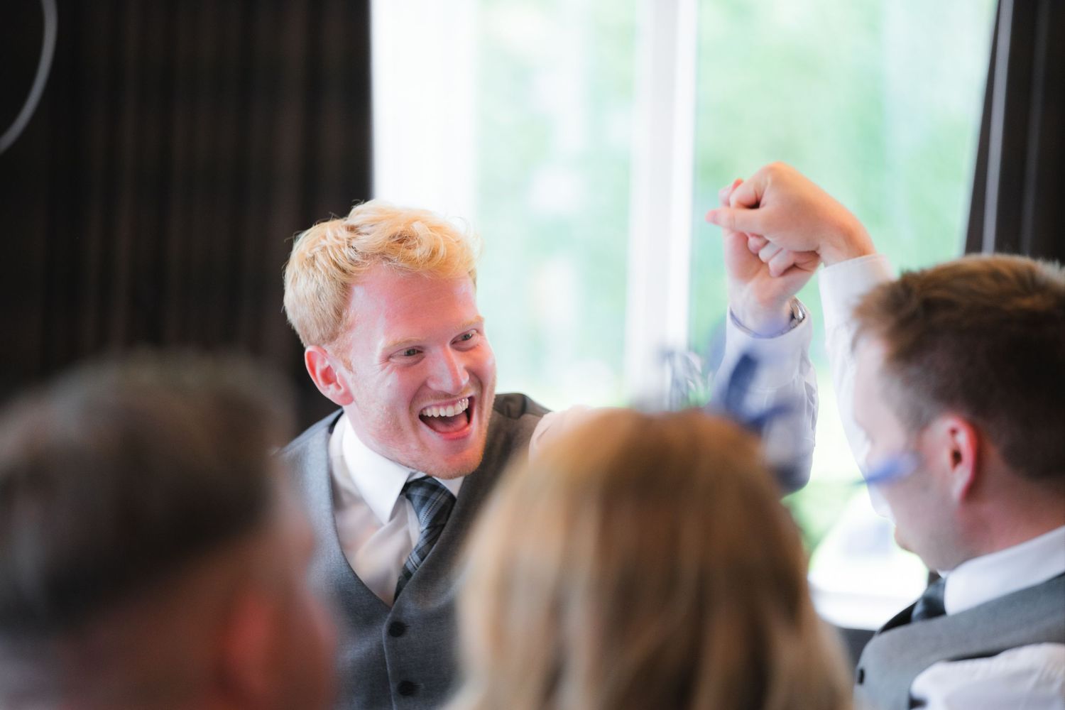 Candid shots of guests enjoying the wedding reception with laughter, toasts, and genuine moments
