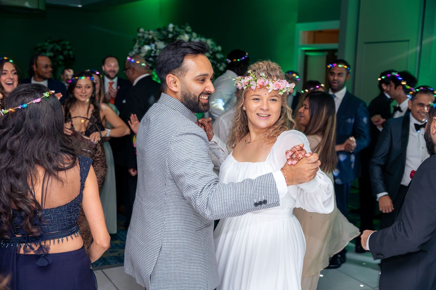 Candid shots of guests enjoying the wedding reception with laughter, toasts, and genuine moments.