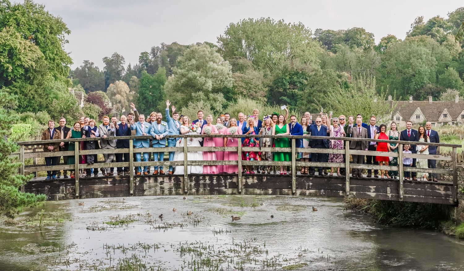 Group wedding photo with family and friends, taken by R&S Oxfordshire Photographers in a candid, relaxed style.