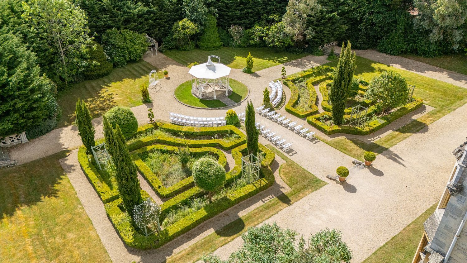 Drone aerial view of the wedding venue and guests, highlighting scenery and setting from above.