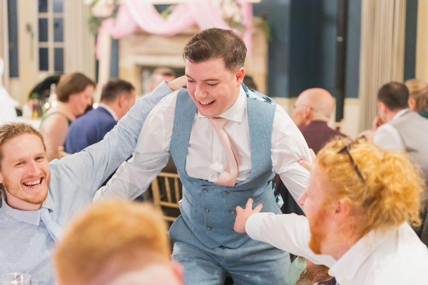 Candid shots of guests enjoying the wedding reception with laughter, toasts, and genuine moments.