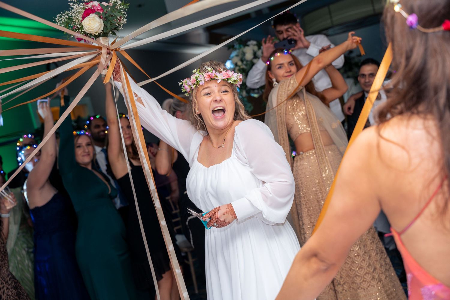 Candid shots of guests enjoying the wedding reception with laughter, toasts, and genuine moments.