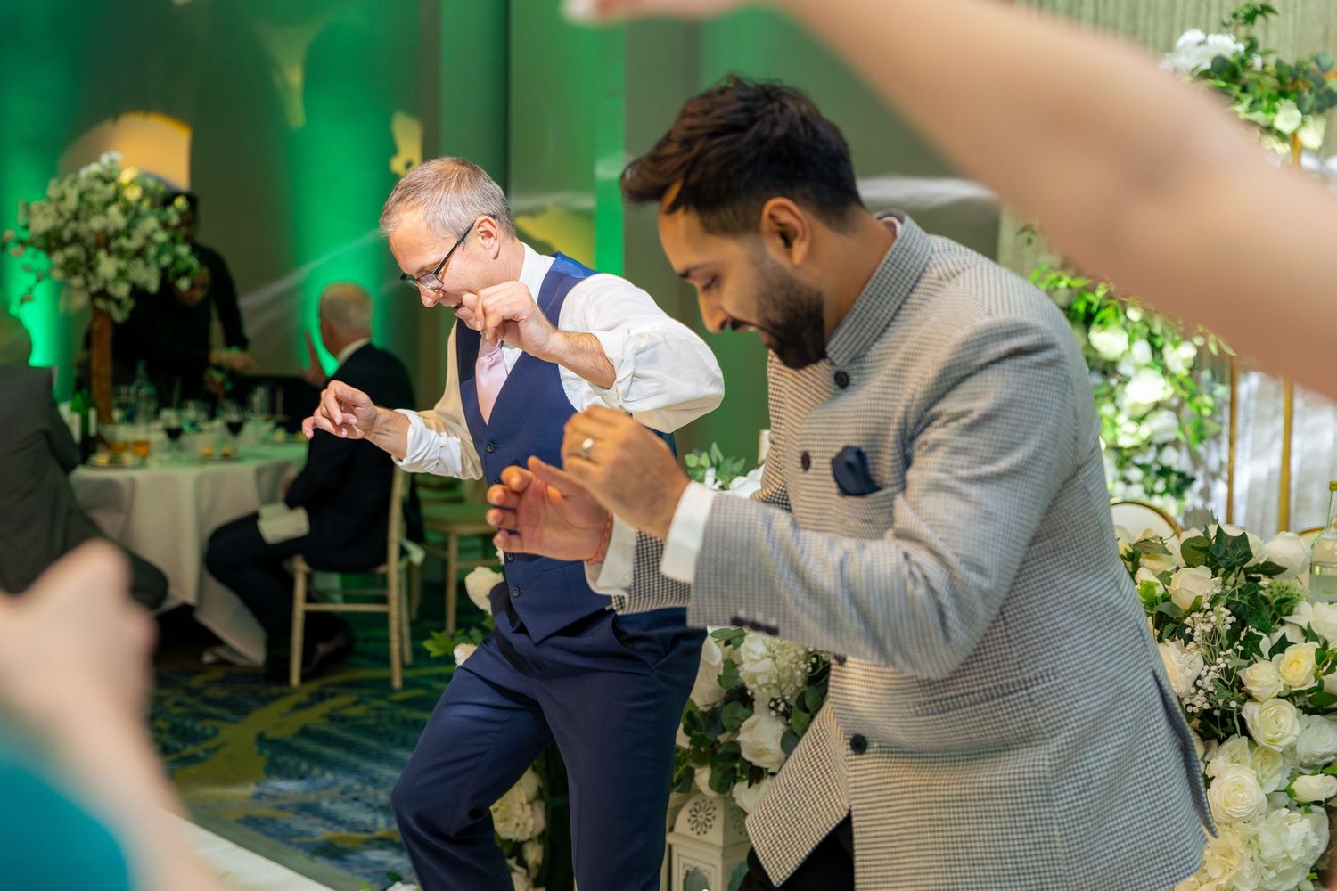 Candid shots of guests enjoying the wedding reception with laughter, toasts, and genuine moments.