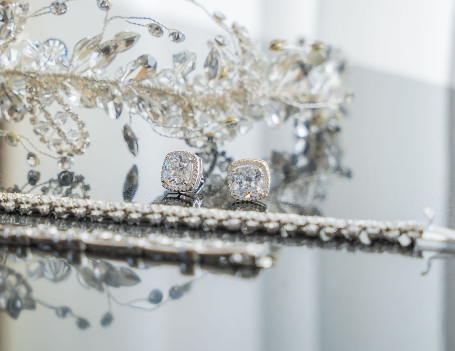 Close-up wedding details including rings, dress, flowers, and accessories, beautifully styled and lit.