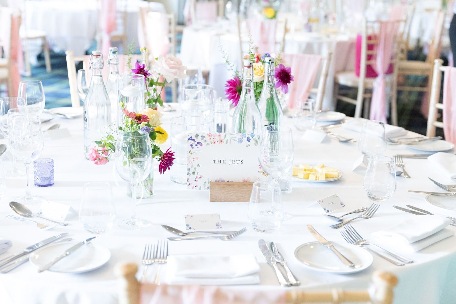 Close-up wedding details including rings, dress, flowers, and accessories, beautifully styled and lit.