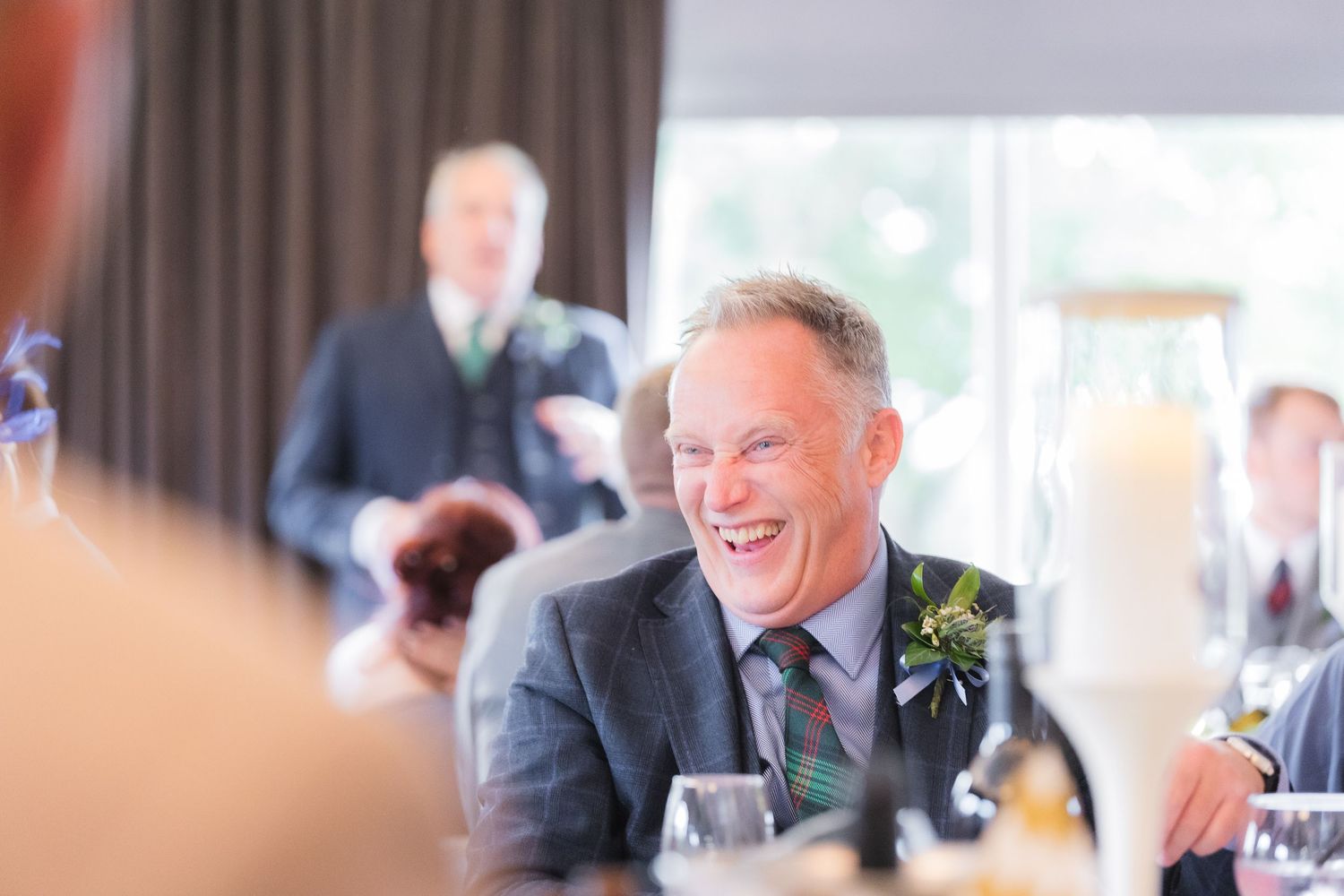 Candid shots of guests enjoying the wedding reception with laughter, toasts, and genuine moments