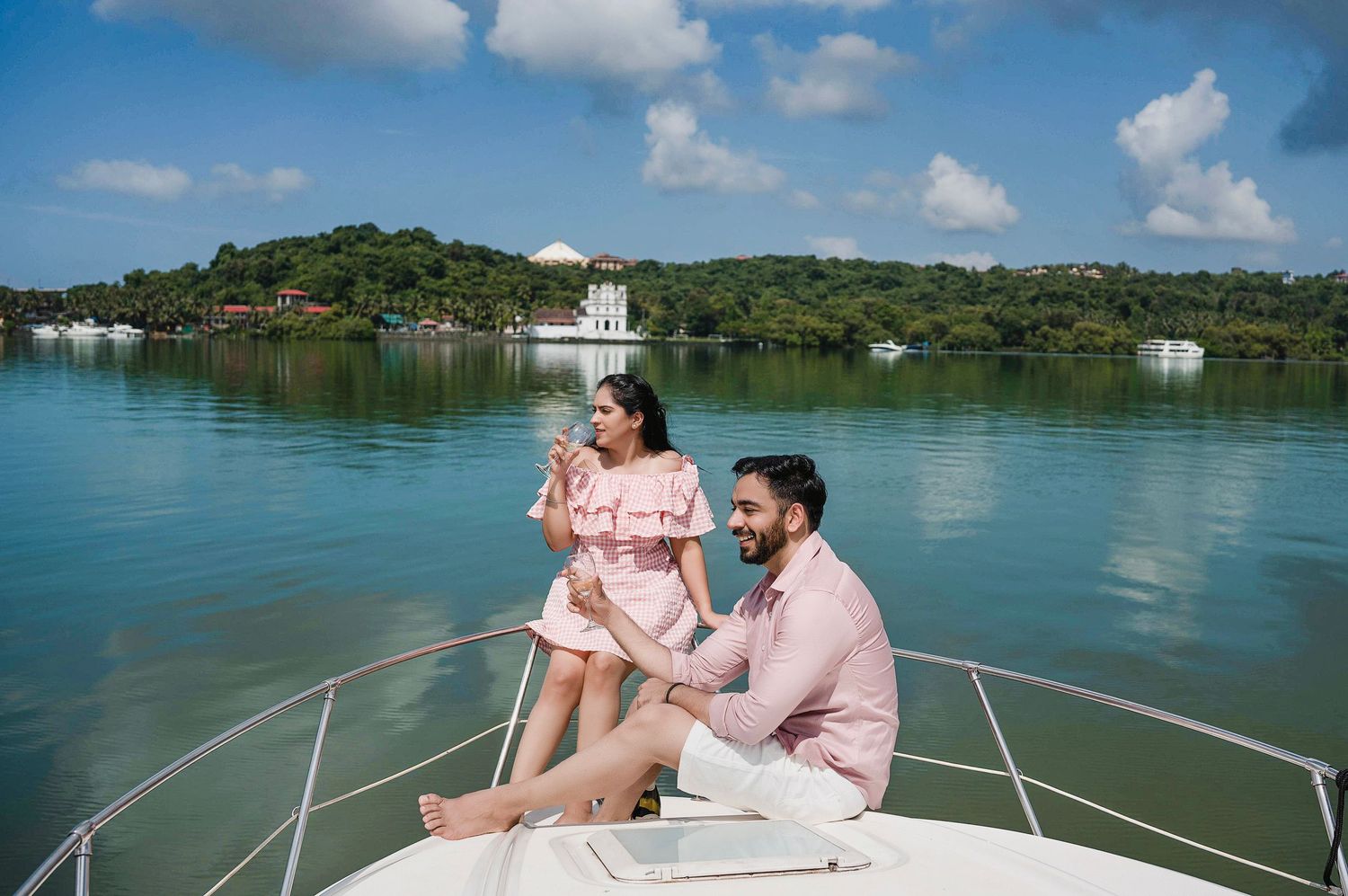 Scenic boat tour on calm tropical waters with lush green islands in the background.