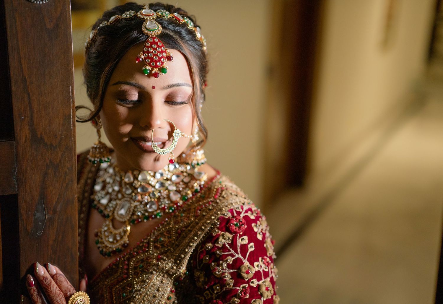 Traditional bridal jewelry and attire details captured in warm lighting with intricate embellishments.