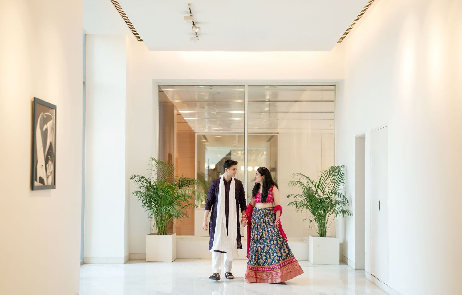 Modern minimalist white hallway with clean lines and ambient lighting.