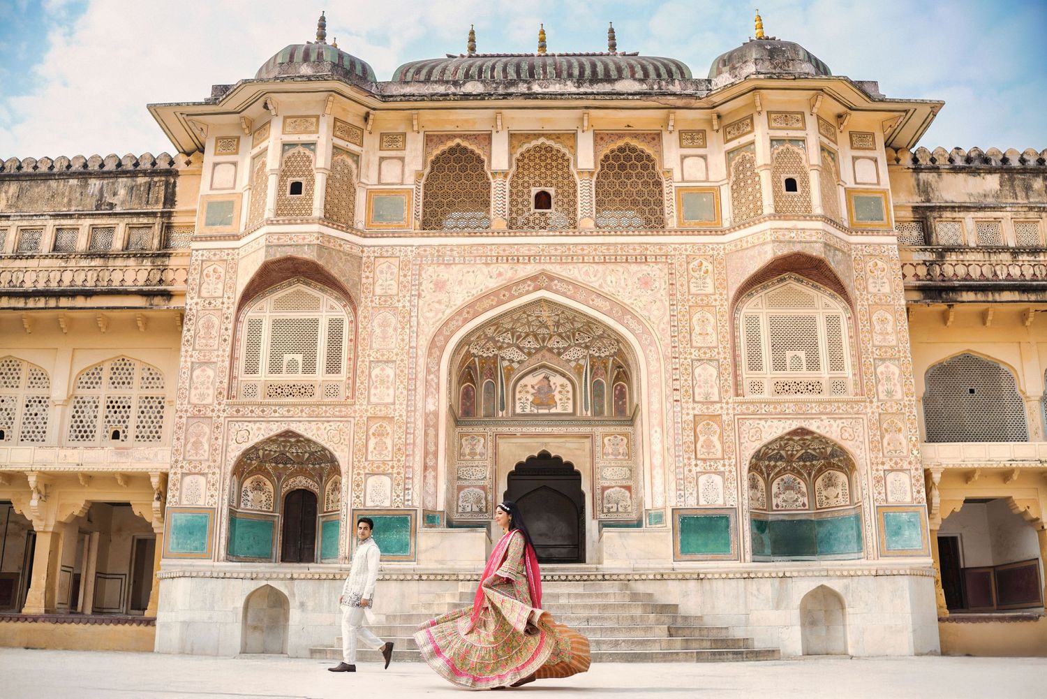 Historic Indian palace architecture featuring detailed sandstone carvings and ornate designs.