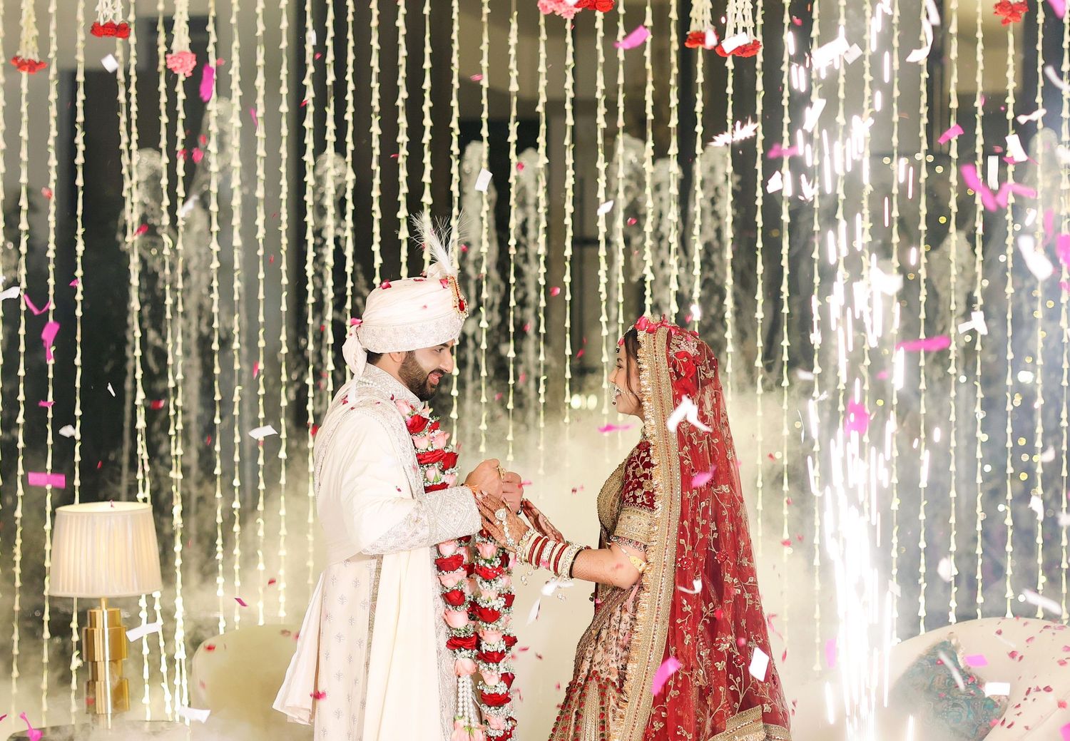 Wedding ceremony space with hanging crystal decorations and traditional Indian wedding decor.