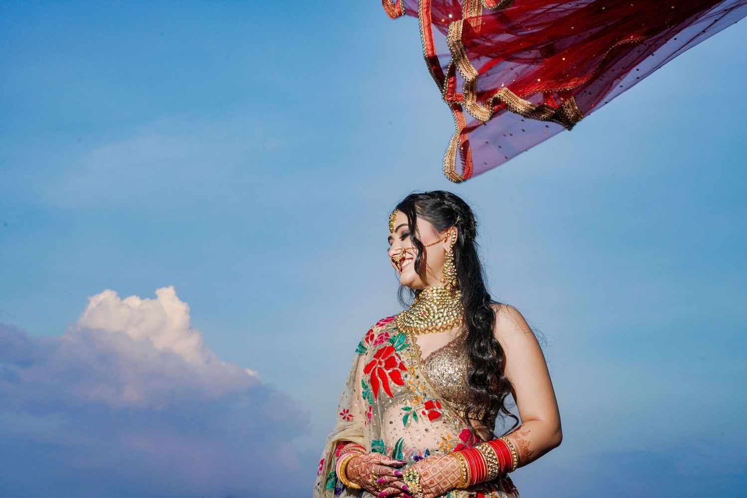 Artistic photographs captured against a bright blue sky with flowing fabric creating dynamic movement.