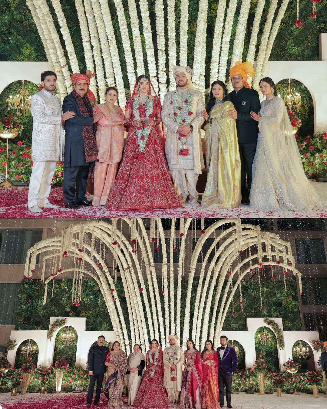 Indian wedding couple in traditional attire posing with family under floral arch decoration.