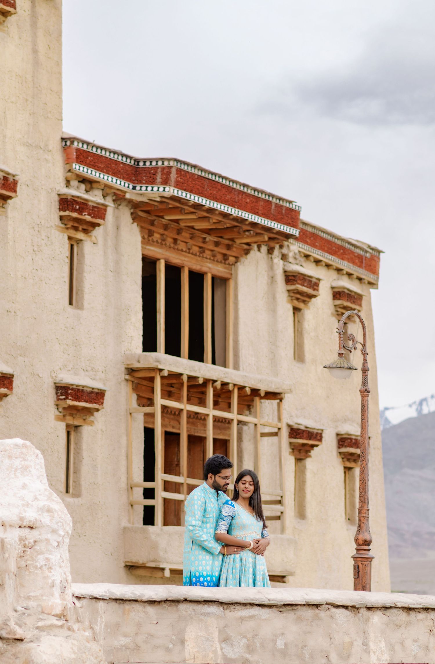 Historic Ladakhi palace architecture featuring traditional wooden windows and balconies.