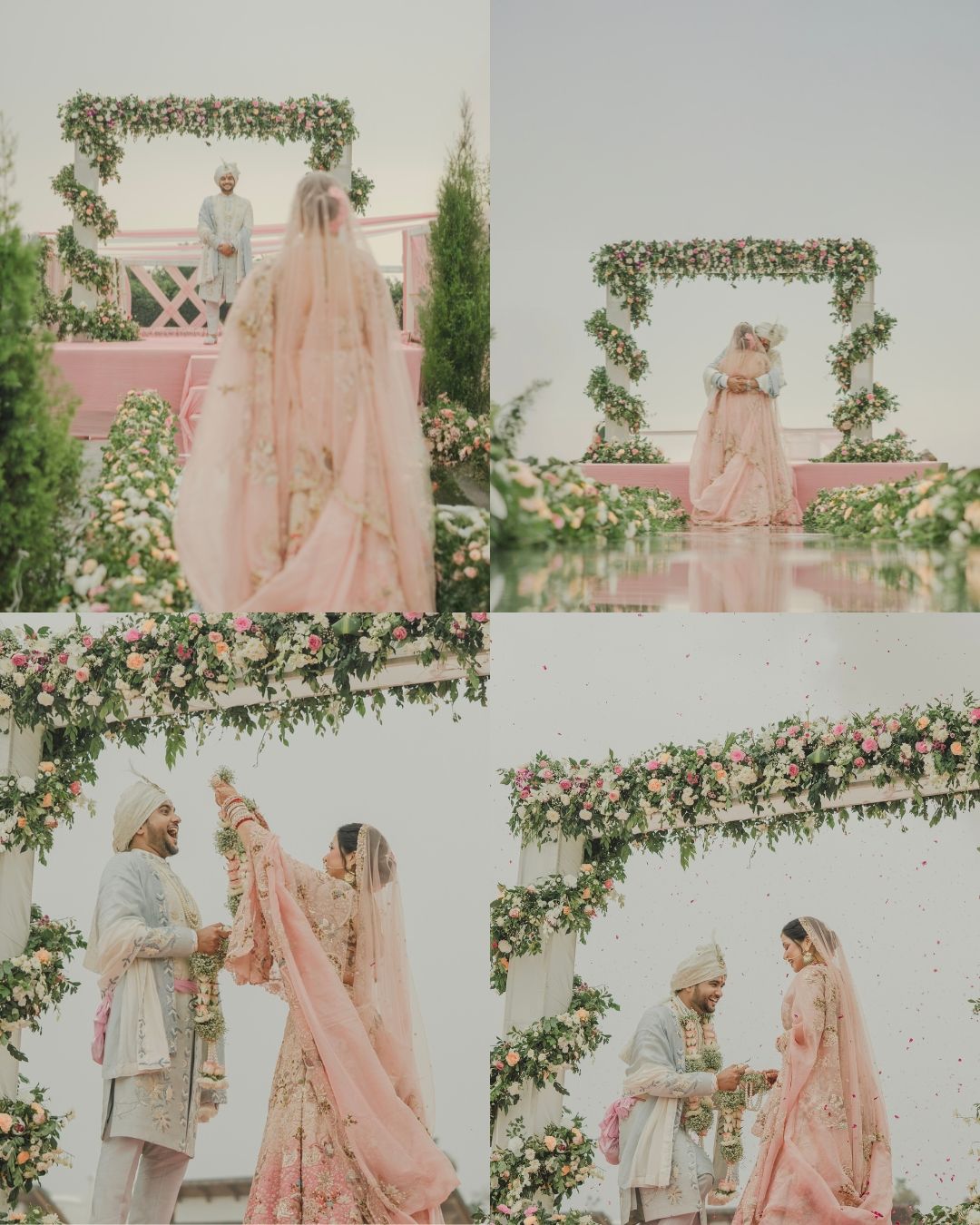 Elegant South Asian wedding ceremony with bride in pink lehenga and groom in gray sherwani under floral arch outdoors.
