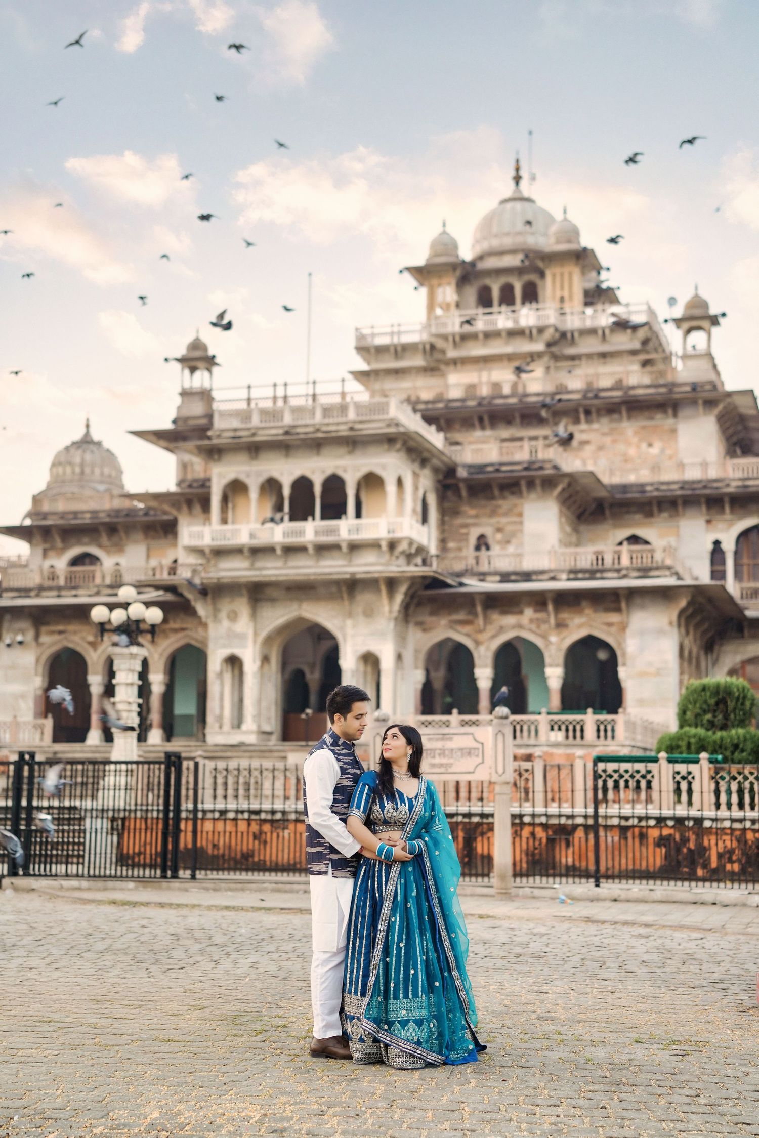 Beautiful Indian palace architecture with ornate white domes and pillars at sunset.