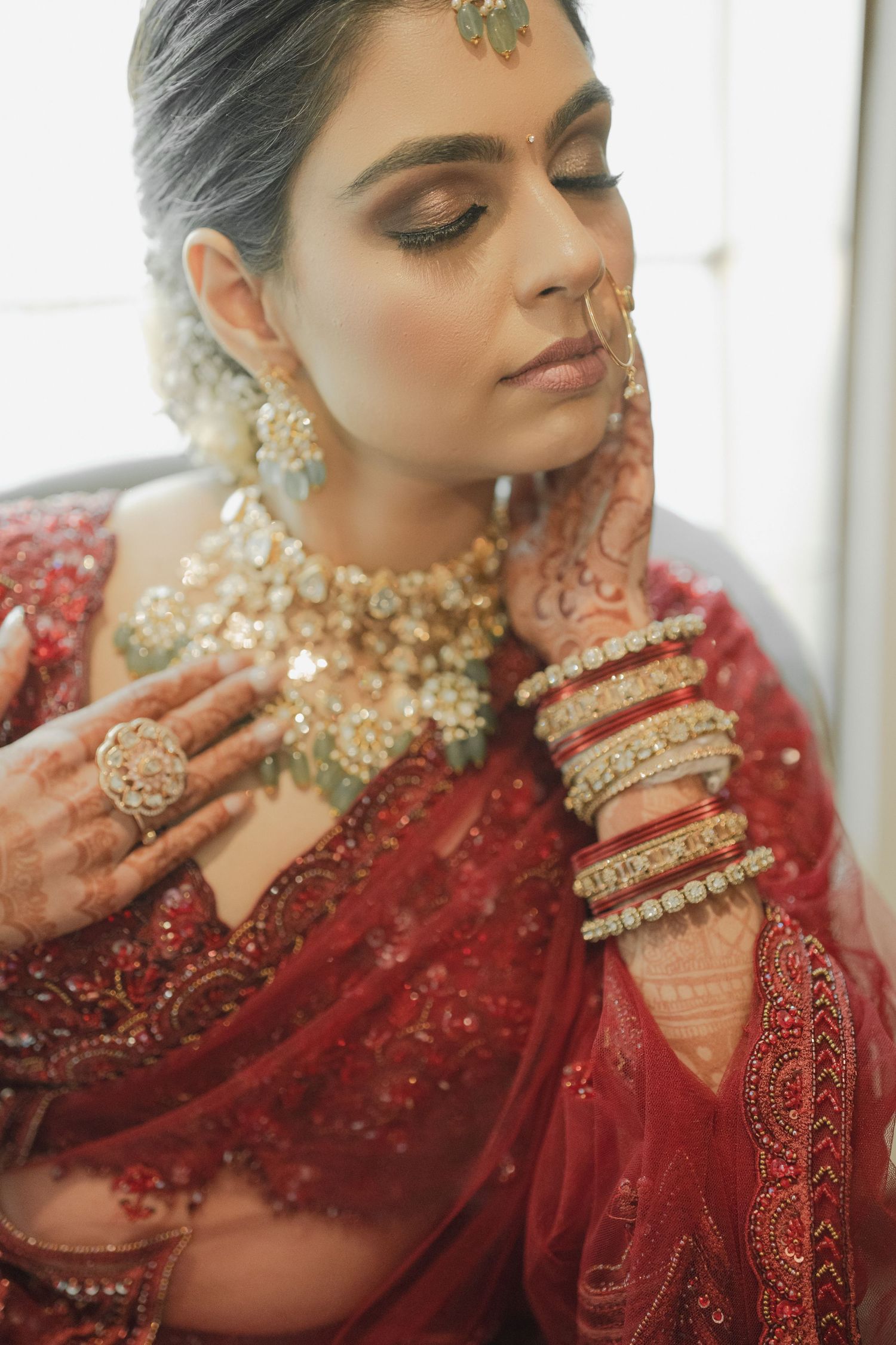 Close-up shots of traditional South Asian bridal jewelry and red embroidered attire with intricate details and ornate designs.