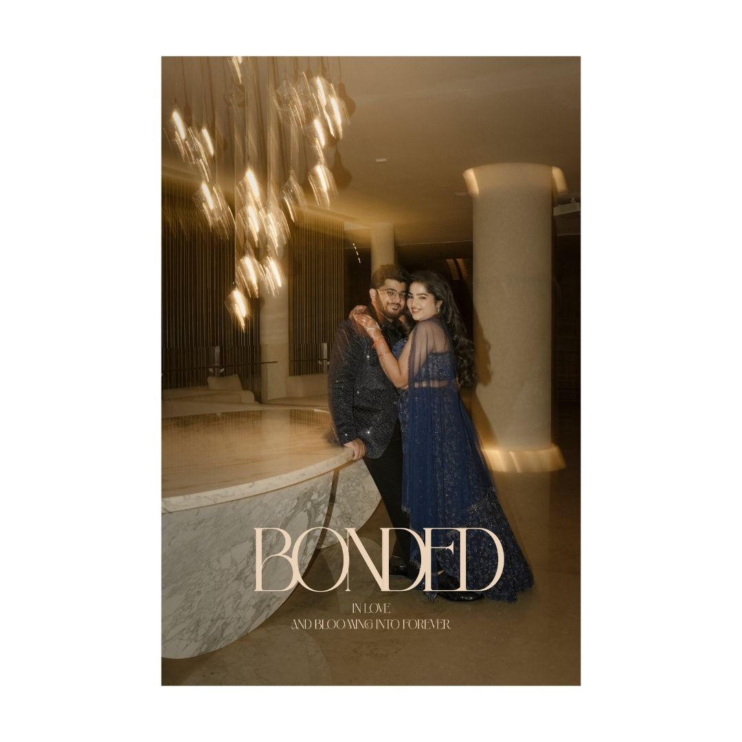Couple in elegant blue outfits pose together in a warmly lit venue, featured on a wedding card titled Bonded.