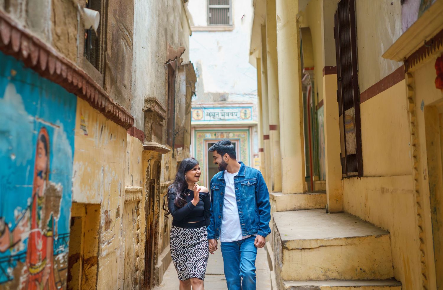 Yellow painted narrow alleyway with traditional architecture and colorful walls.