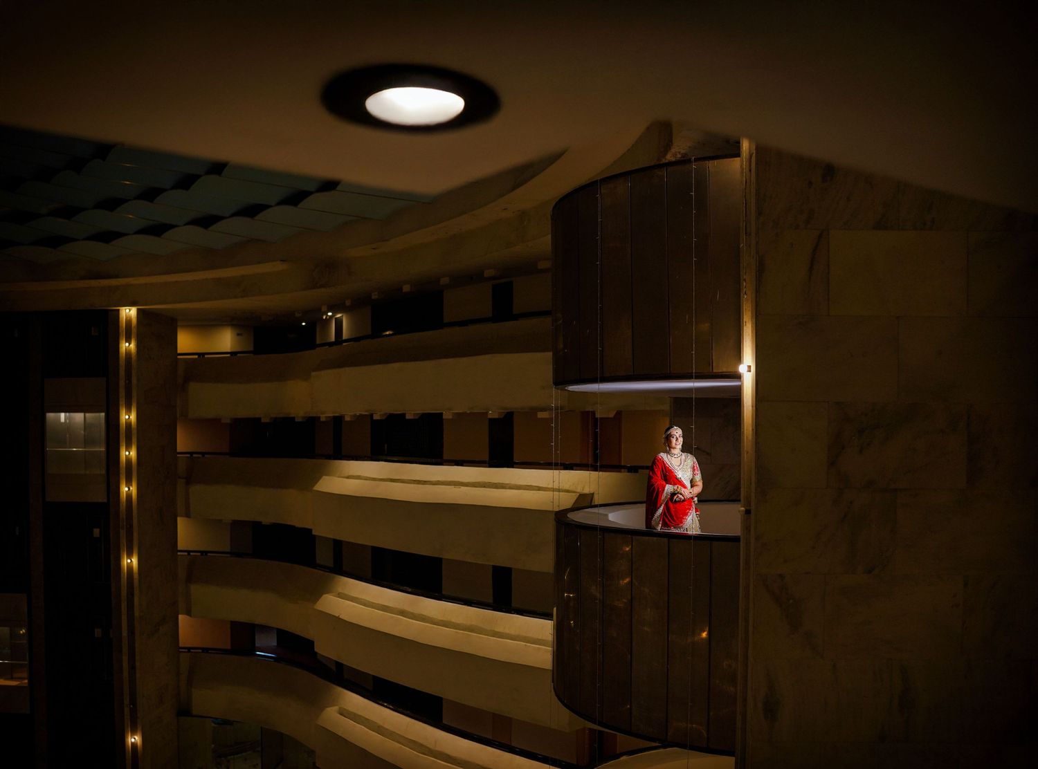Dark atmospheric interior shots of an elegant venue with dramatic lighting and architectural details.