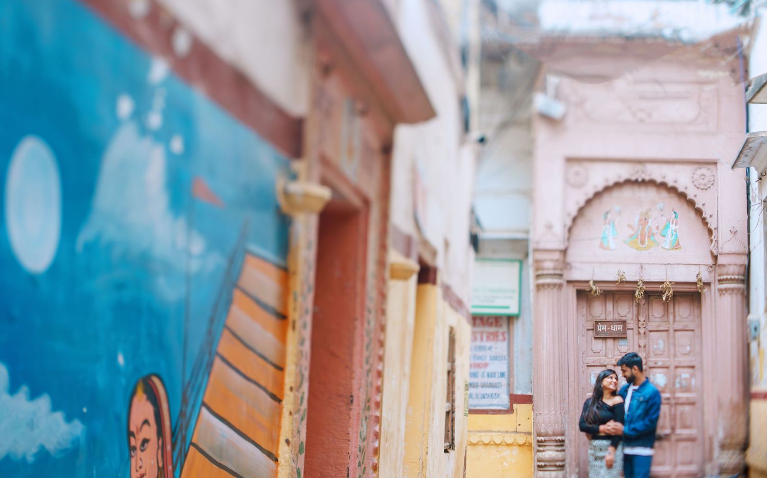 Blue-tinted urban alley with historic architecture and decorative details.