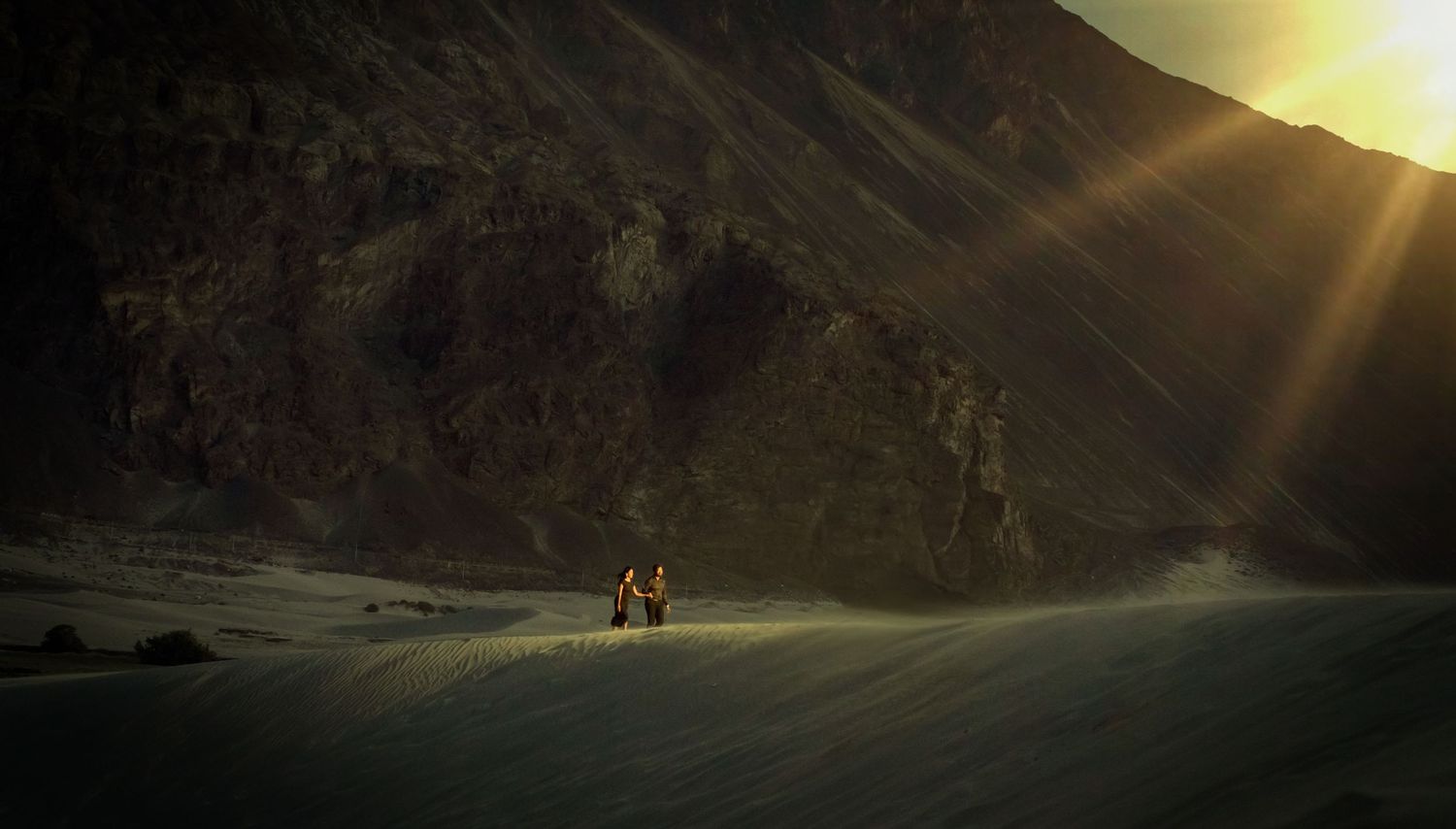 Silhouettes against a golden sunset in the rugged mountain landscape of Ladakh.