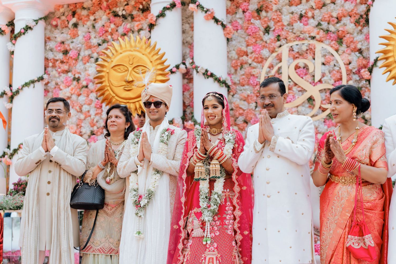 Colorful Indian wedding ceremony backdrop with sun motifs and floral decorations.