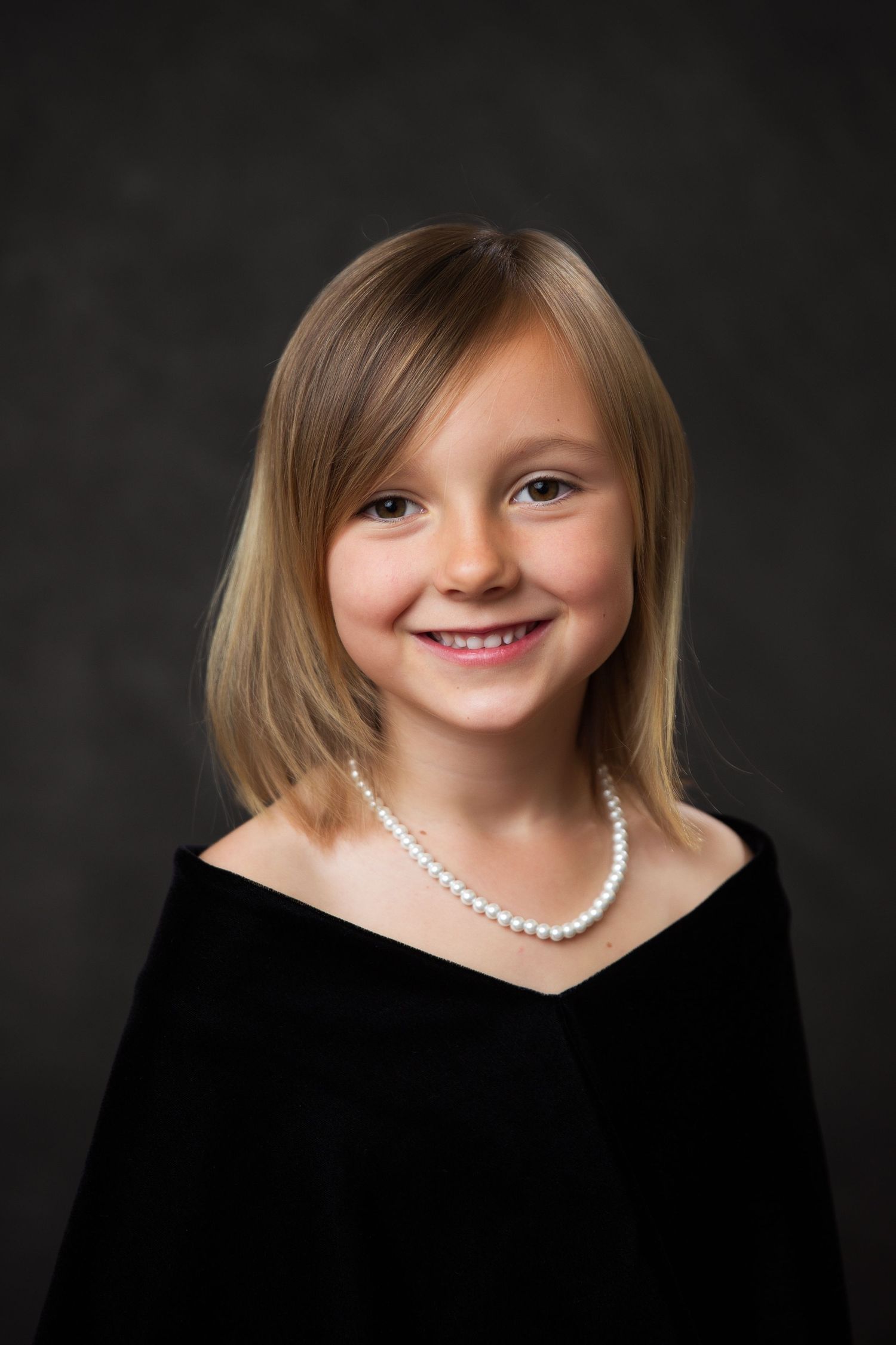 Classic portrait of a kindergarten graduate in drape senior session style.