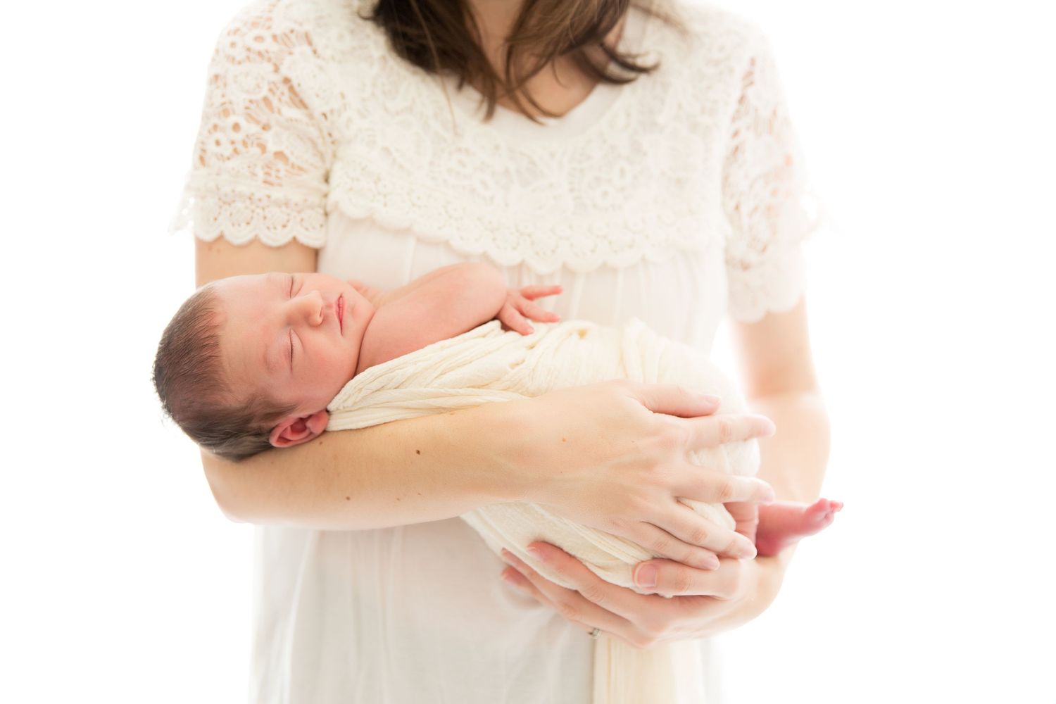 Spanning horizontal series of intimate and tender maternity photos showing softly lit close-ups in light tones.
