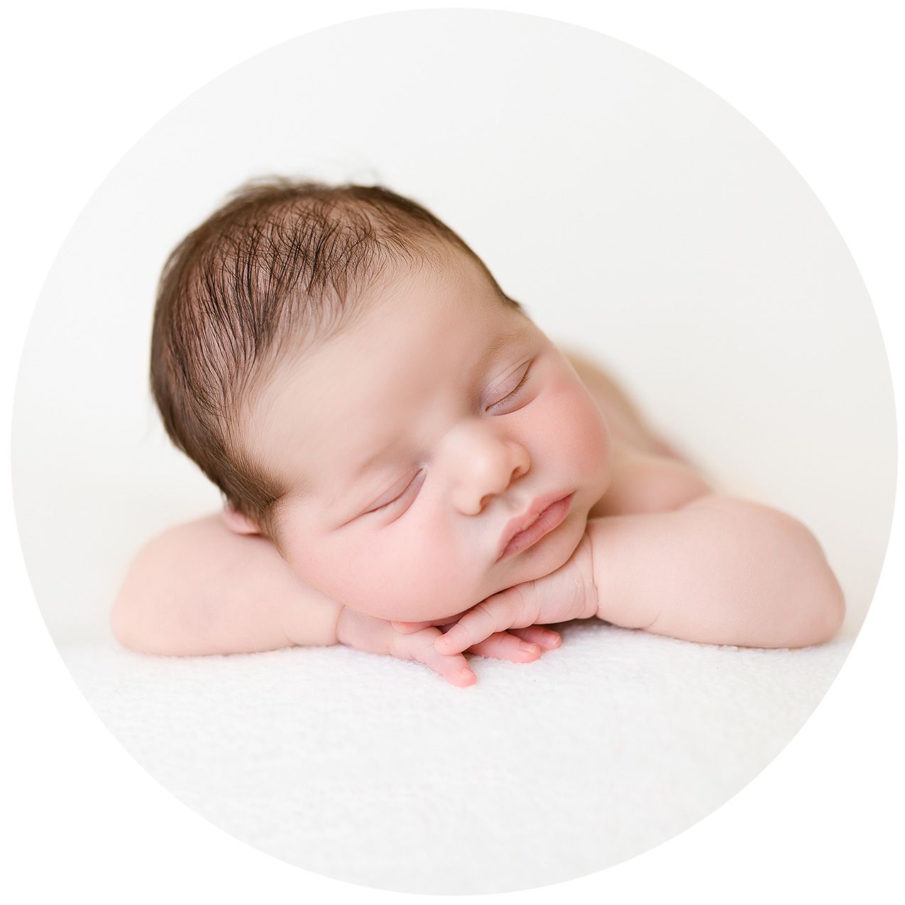 Peaceful sleeping newborn baby in soft natural light rests on a white background showing multiple dreamy poses.