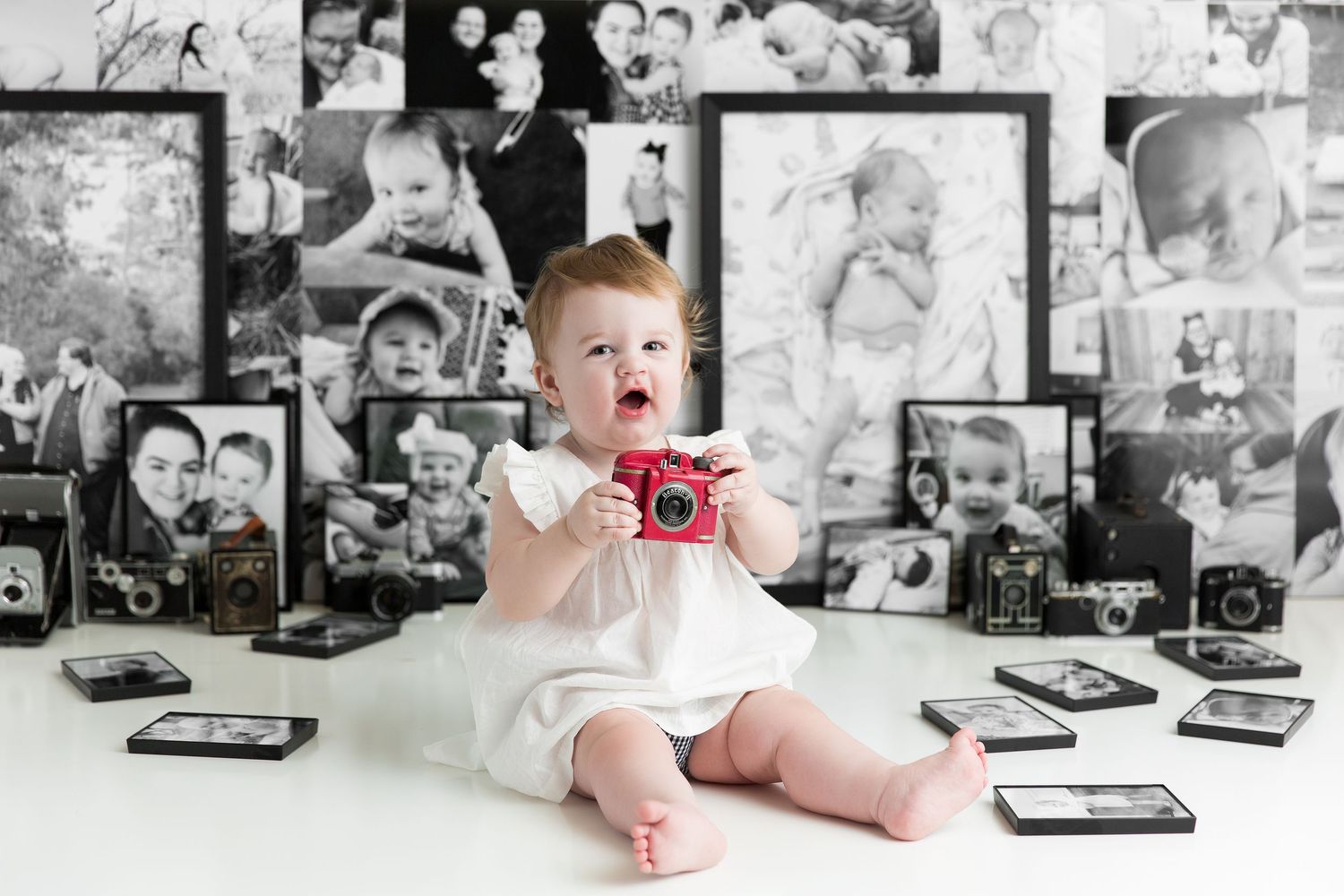 Black and white photo collage showing baby milestones with all their first photos and vintage family cameras.