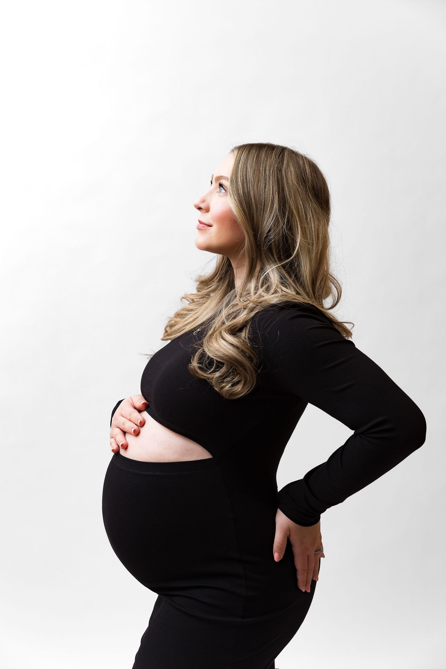 Maternity photography series showing elegant poses against a white background.