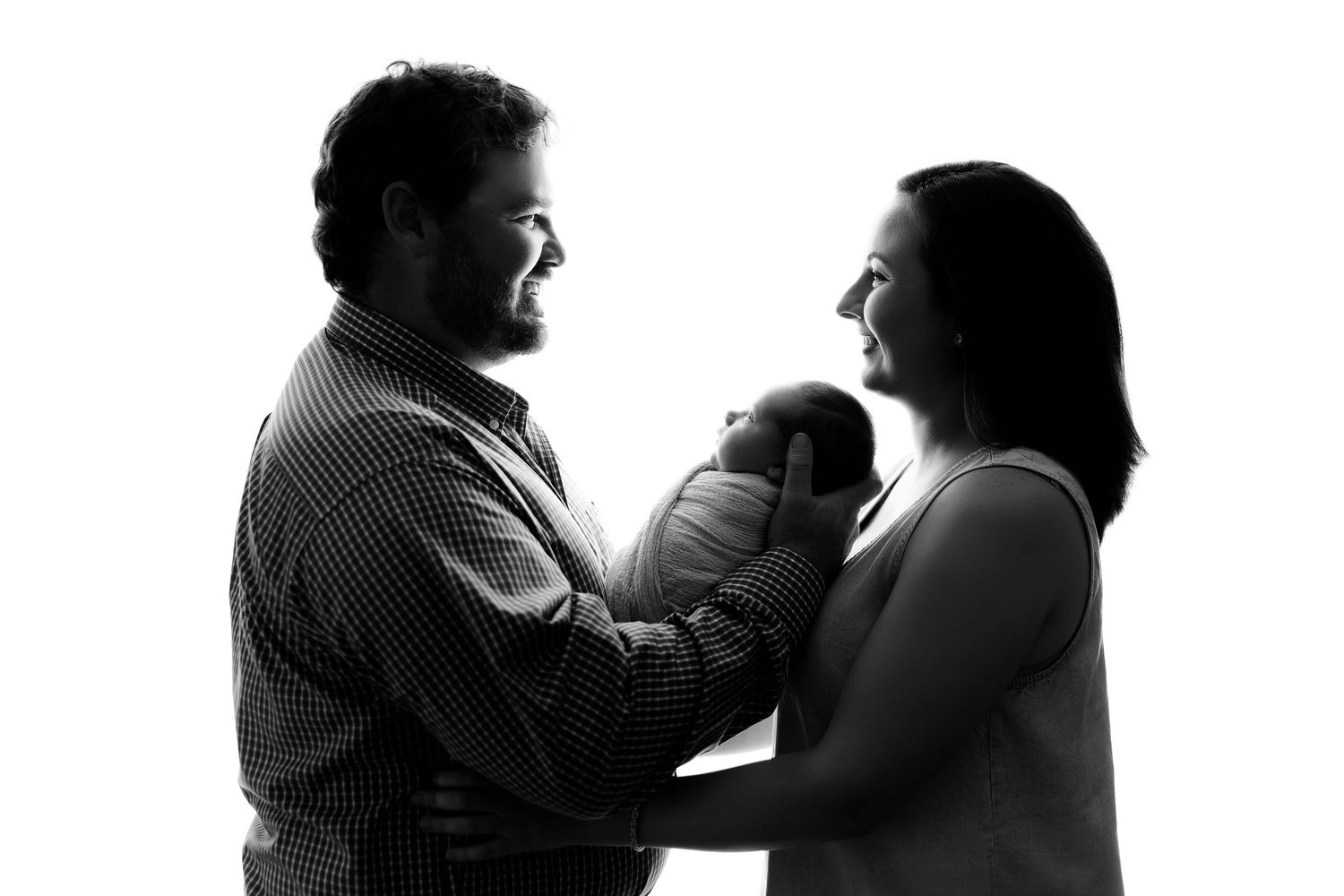Artistic black and white silhouette series showing family interaction.