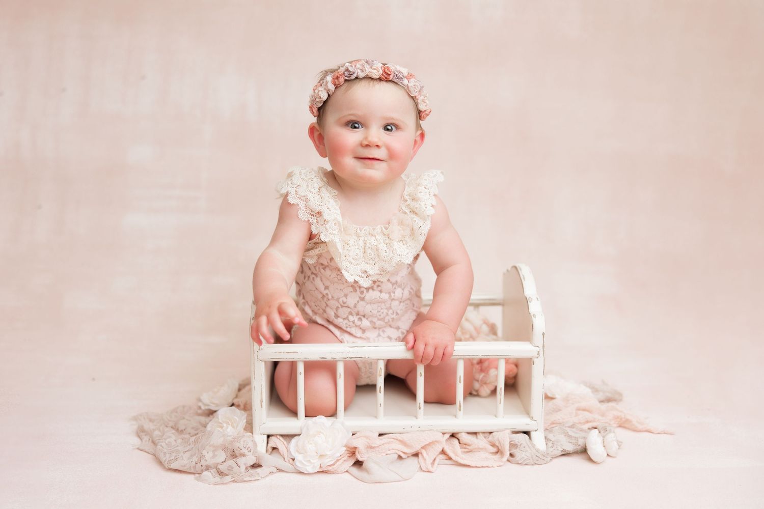 Professional baby photography session with vintage pink decor and floral backdrop showing multiple poses.