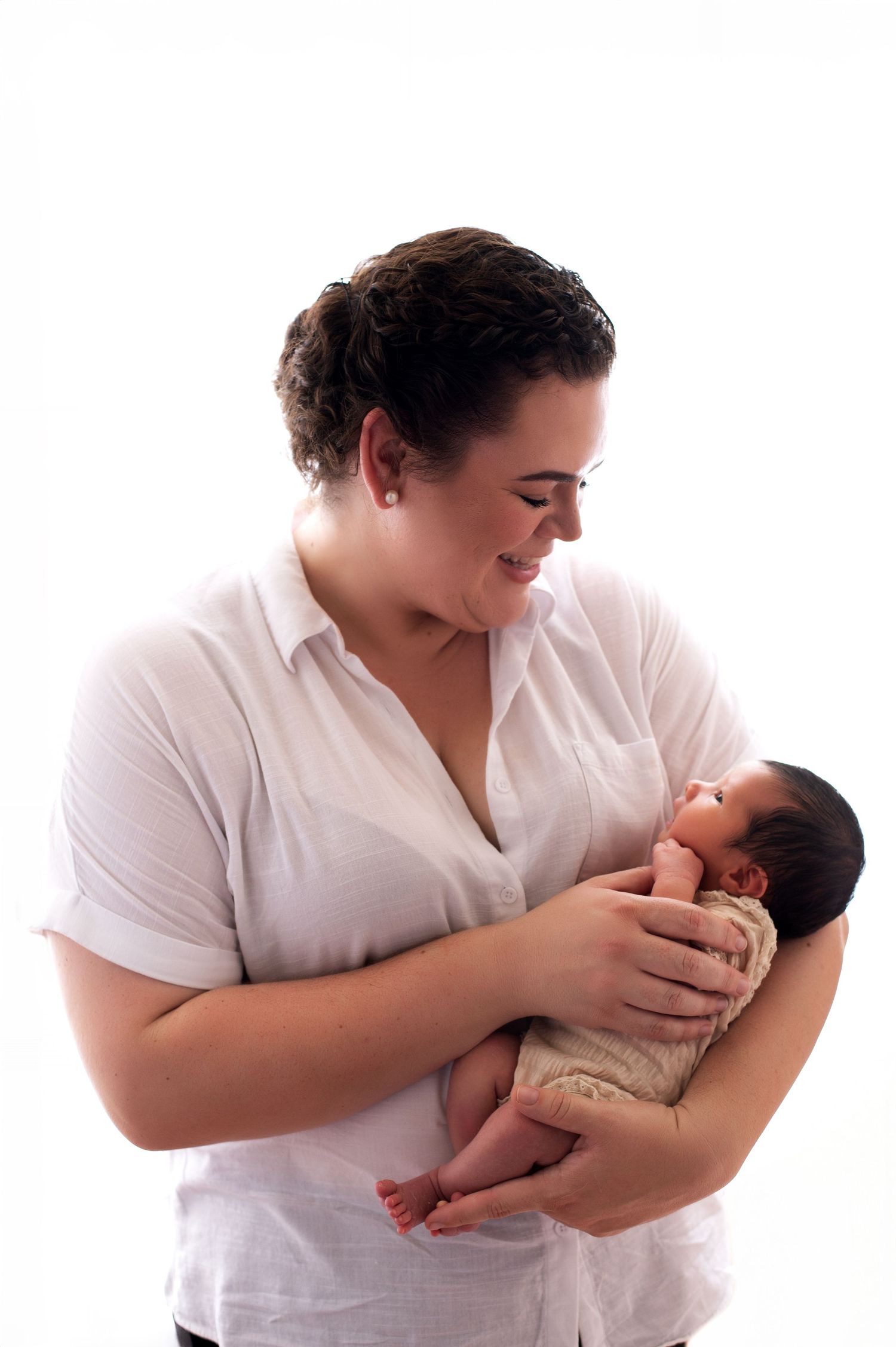 A series of four intimate photos showing tender moments of nursing and bonding with a newborn baby.