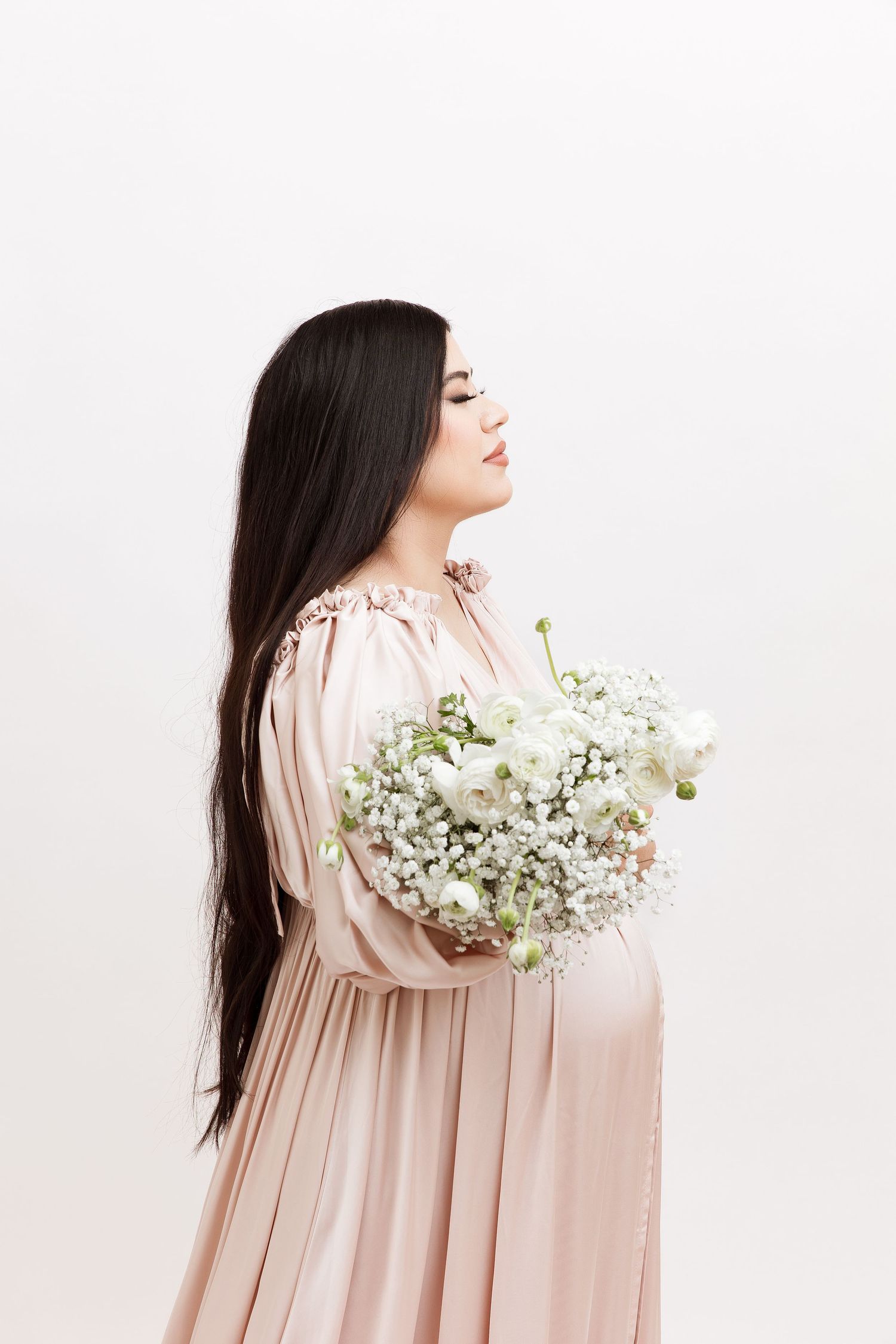 Side profile portrait with baby's breath flowers and flowing pink dress.